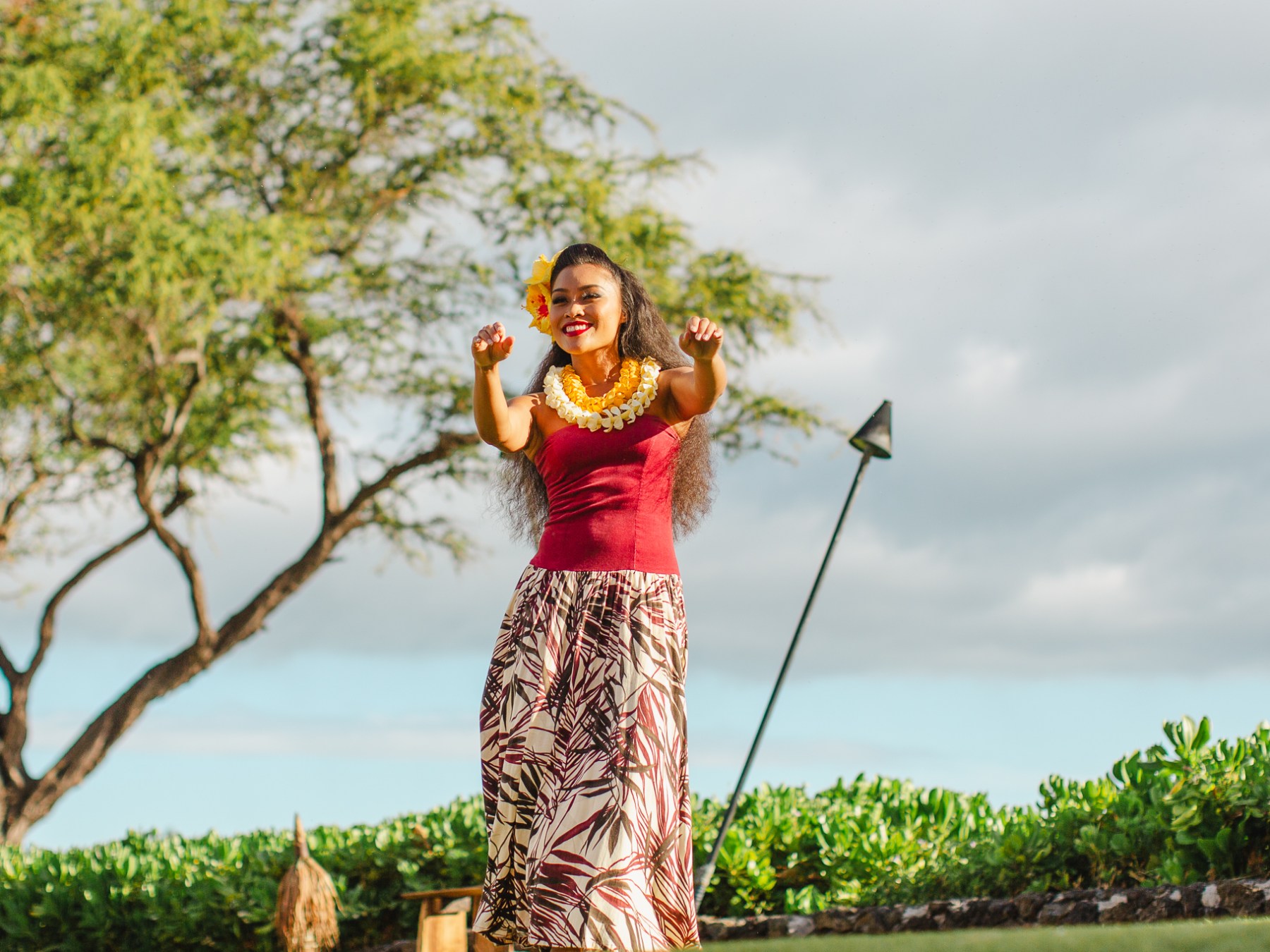 Women in Red Shirt and Long Skirt Performing Luau with Arms